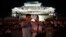 FILE - A North Korean couple use their smartphone to photograph fireworks in Pyongyang, July 27, 2014.