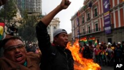 Opponents of Bolivia's President Evo Morales celebrate after he announced his resignation in La Paz, Bolivia, Nov. 10, 2019. 