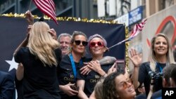 Members of the U.S. women's soccer team, including Megan Rapinoe, center and Julie Ertz, at right waving, celebrates during a ticker tape parade along the Canyon of Heroes, Wednesday, July 10, 2019, in New York. The U.S. national team beat the…