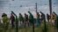 Migrants who successfully crossed the Eurotunnel terminal walk on the side of the railroad as they try to reach a shuttle to Great Britain, July 28, 2015 in Frethun, northern France.