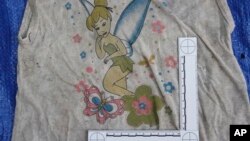 In this undated photo provided by the Veracruz State Prosecutor's Office shows a clothing item found at the site of a clandestine burial pit in the Gulf coast state of Veracruz, Mexico. Veracruz state prosecutor Jorge Winckler said the bodies were buried at least two years ago and did not rule out finding more remains. He said investigators had found 114 ID cards in the field, which held about 32 burial pits.