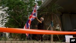 A pro-democracy supporter holds a British flag outside a court in Hong Kong, April 1, 2021.