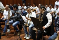 Inmates take their seats as they prepare to take part in a classical music session with the symphony orchestra as part of a pioneering project to rehabilitate criminals in Lima, Peru, July 19, 2019.