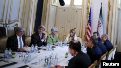 FILE - U.S. Secretary of State John Kerry (2nd R) meets with the Iranian delegation including Iranian Foreign Minister Mohammad Javad Zarif at a hotel where the Iran nuclear talks meetings are being held in Vienna, Austria, July 2, 2015.