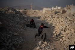 Children play surrounded by rubble on a an area of houses that were destroyed during the civil war at the Al-Asali neighbourhood in Damascus, Syria, Jan. 6, 2025.