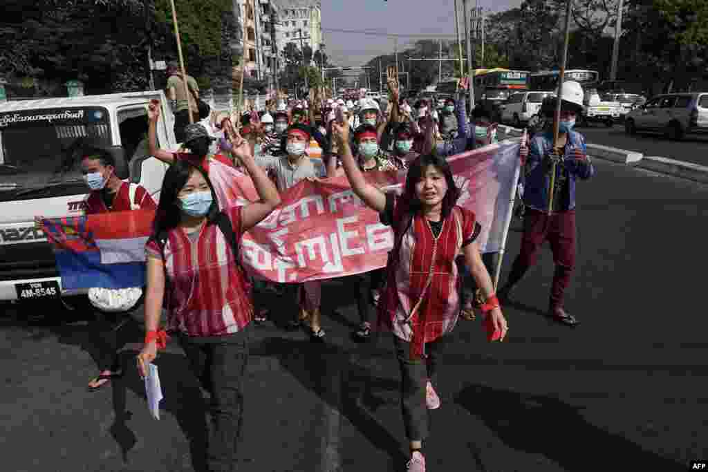 Protesters hold up the three finger salute during a demonstration against the military coup in Yangon on February 6, 2021. (Photo by STR / AFP)