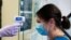 Jillian Golder, an employee of Oro Valley Hospital, has her temperature checked before receiving an antibody test for the coronavirus disease (COVID-19) at the University of Arizona in Tucson, Arizona, July 10, 2020.