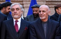 FILE - Afghan presidential election opposition candidate Abdullah Abdullah, left, and Afghanistan's President Ashraf Ghani are seen after a press conference at the presidential palace in Kabul, Feb. 29, 2020.