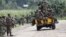 M23 rebel fighters sit on a truck as they prepare to withdraw near the town of Sake, 42 kilometers west of Goma in eastern Congo, November 30, 2012.