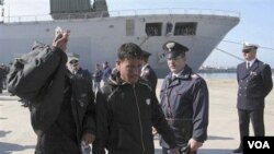 Para pengungsi dari Libya tiba di pelabuhan Taranto, Italia bagian selatan, Senin (28/3).