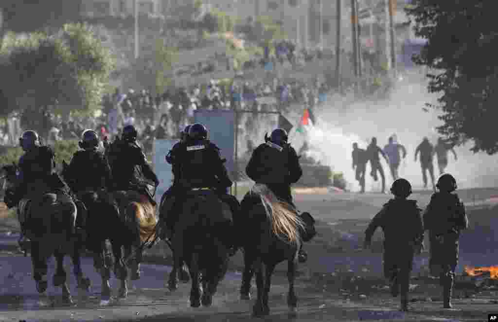 Israeli riot police officers clash with Israeli Arab during a protest over the fatal shooting of a 22-year-old Arab Israeli who appeared in video footage to be retreating from police, in the Arab village of Kfar Kana, northern Israel.