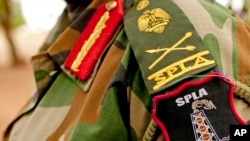 A Sudan People's Liberation Army (SPLA) commander dons his division's insignia in Bentiu, Unity State, South Sudan.