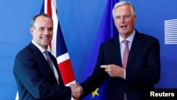 Britain's Secretary of State for Exiting the European Union, Dominic Raab and European Union's chief Brexit negotiator, Michel Barnier, pose ahead of a meeting in Brussels, Belgium, July 19, 2018.