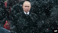 FILE - Russian President Vladimir Putin attends a wreath-laying ceremony at the Tomb of the Unknown Soldier in Moscow, Russia, Feb. 23, 2017.