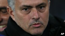 Chelsea Manager José Mourinho looks across the pitch before the Champions League Group G soccer match between Chelsea and Sporting Lisbon at Stamford Bridge in London, Wednesday, Dec. 10, 2014. (AP Photo/Tim Ireland)