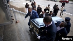 FILE - Pallbearers carry the casket of Quintonio LeGrier during his funeral in Chicago, Jan. 9, 2016. LeGrier was fatally shot by a Chicago police officer after allegedly swinging a baseball bat at him. Last year, Chicago's homicide toll soared to 762 - more than New York and Los Angeles combined.