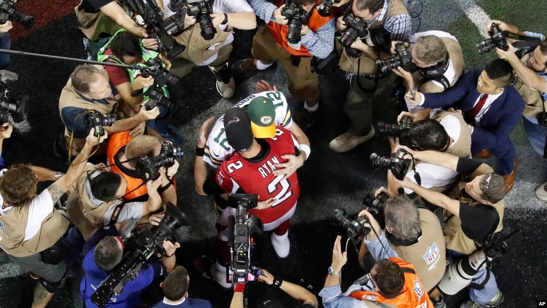 Atlanta Falcons quarterback Matt Ryan (2) embraces Green Bay Packers quarterback Aaron Rodgers (12) after the NFL football NFC championship game Sunday, Jan. 22, 2017, in Atlanta.