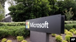 The Microsoft company logo is displayed at their offices in Sydney, Feb. 3, 2021. Microsoft says it supports Australia's plans to make the biggest digital platforms pay for news.