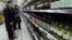 Chinese shoppers look at rows of wine at a supermarket in Shanghai. (March 2002 file photo)