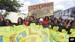 Protesters march during a climate change rally outside a climate change summit held in the city of Durban, South Africa, Friday, Dec 2, 2011. (AP Photo/Schalk van Zuydam)