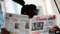 FILE - A man reads the official newspaper of the Central Committee of the Cuban Communist Party, Granma, in old Havana, Feb. 3, 2015.