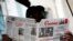FILE - A man reads the official newspaper of the Central Committee of the Cuban Communist Party, Granma, in old Havana, Feb. 3, 2015.
