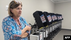 Veronica Johnson, director of elections and registration at the Lee County Board of Elections and Registration, speaks next to voting machines before poll worker training in Leesburg, Georgia, Oct. 2, 2024.