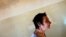 FILE - A patient is seen walking toward a group therapy room at a mental health institution in the Balkans.