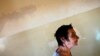 FILE - A patient is seen walking toward a group therapy room at a mental health institution in the Balkans.