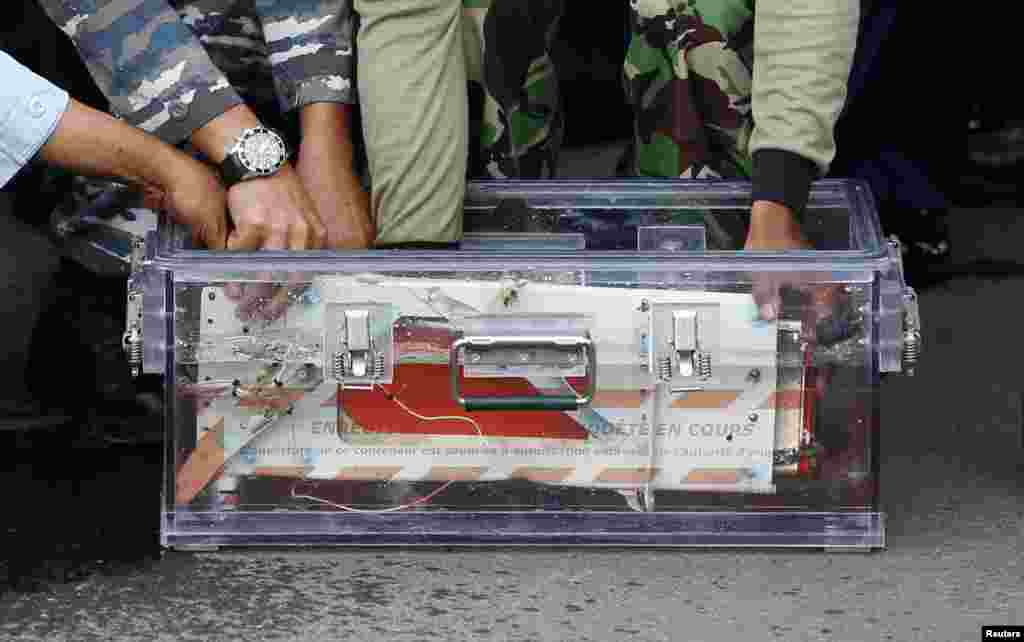 The flight data recorder from AirAsia QZ8501 is placed into a container upon its arrival at the airbase in Pangkalan Bun, Central Kalimantan January 12, 2015.