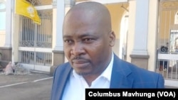 Charles Kwaramba, of the group Zimbabwe Lawyers for Human Rights, speaks to reporters outside Harare Magistrates Court, Sept. 4, 2024.