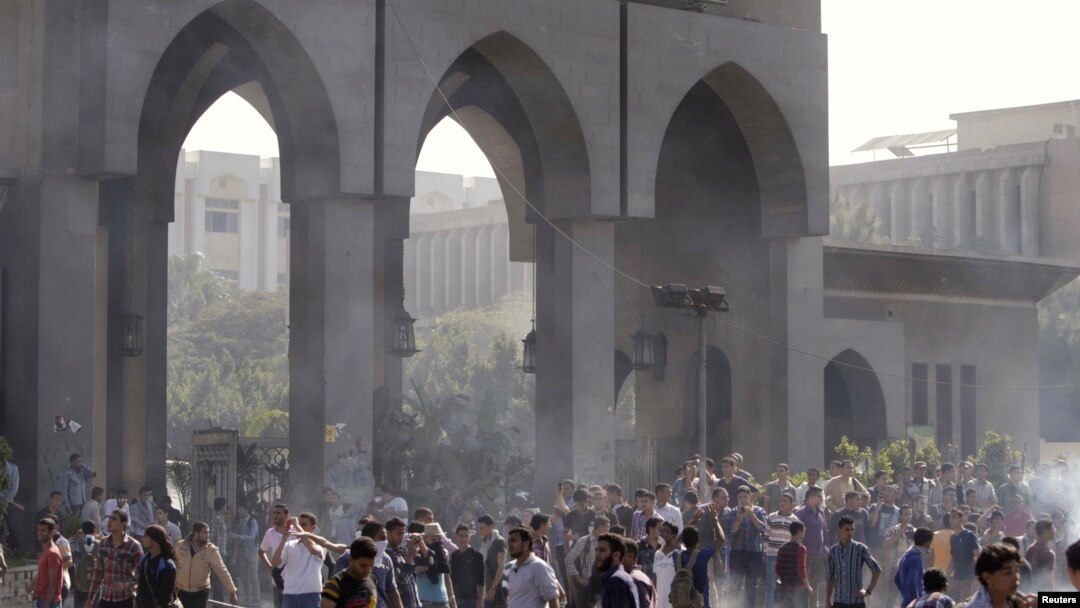 Protesters are seen amid remnants of teargas smoke during clashes with riot police at al-Azhar University in Cairo October 20, 2013. 