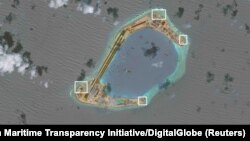 A satellite image shows what CSIS Asia Maritime Transparency Initiative says appears to be anti-aircraft guns and what are likely to be close-in weapons systems (CIWS) on the artificial island Subi Reef in the South China Sea in this image released on Dec. 13, 2016.