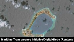 A satellite image shows what CSIS Asia Maritime Transparency Initiative says appears to be anti-aircraft guns and what are likely to be close-in weapons systems (CIWS) on the artificial island Subi Reef in the South China Sea in this image released on Dec