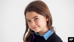 Actress Brooklynn Prince poses for a portrait in New York to promote her film, "The Florida Project," Nov. 28, 2017.