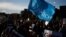 FILE - A protester holds a peace flag while taking part in the 'National March For Palestine' in central London on November 11, 2023, calling for a ceasefire in the conflict between Israel and Hamas.
