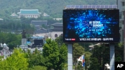 A screen shows an announcement of the AI Seoul Summit in Seoul, South Korea, May 21, 2024.