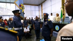 New Chief of Defense Staff, Air Marshal Alex Badeh (C), and the new Air Force Chief Vice Marshal Adesola Nunayon Amosu (R) attend a handing over ceremony in Abuja, Nigeria, Jan. 20, 2014.