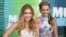 FILE - Tae Dye, right, and Maddie Marlow, of the musical group Maddie & Tae, arrive at the CMT Music Awards in Nashville, Tennessee, June 10, 2015. 