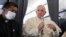 Pope Francis greets journalists onboard the papal plane on the occasion of his pastoral visit to Cyprus and Greece, Dec. 6, 2021. (Alessandro Di Meo/Pool photo via AP)