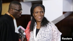 Ivory Coast's former first lady Simone Gbagbo (R), who is accused of crimes against humanity and war crimes for her alleged role in a 2011 civil war, arrives in a domestic court in Abidjan, May 31, 2016.