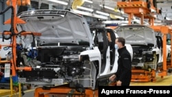 FILE - GMC Hummer EVs are seen on an assembly line at he General Motors Factory ZERO electric vehicle assembly plant in Detroit, Michigan, Nov. 17, 2021. (Photo by MANDEL NGAN / AFP)