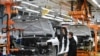 FILE - GMC Hummer EVs are seen on an assembly line at the General Motors Factory ZERO electric vehicle assembly plant in Detroit, Michigan, Nov. 17, 2021.