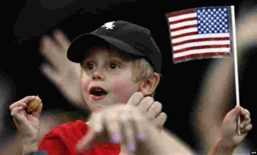 Max Larsen 4, of Steger, Ill., cheers along with the crowd at the -Kansas City Royals-Chicago White Sox baseball game during the seventh inning Monday, July 4, 2011, in Chicago. Chicago won 5-4. (AP Photo/John Smierciak)