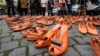 (FILE) Women's rights activists set orange pair of shoes on the pavement for every attempted or successful killing of a woman by partner violence during the International Day for the Elimination of Violence Against Women, in Cologne, Germany, Monday, Nov. 25, 2024.