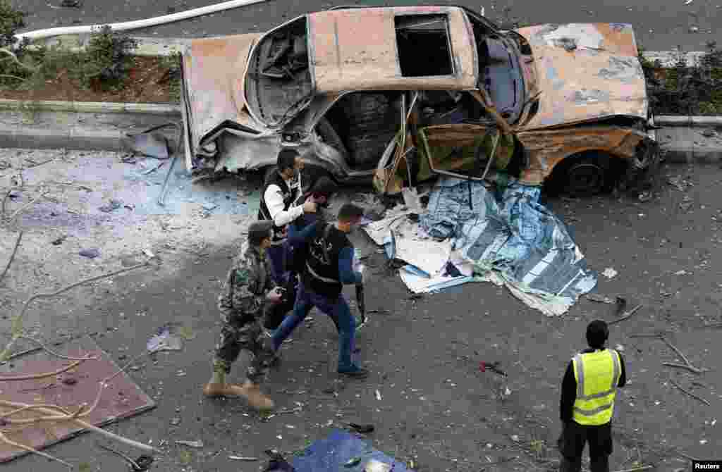 Lebanese police detain a suspect at the site of an explosion in downtown Beirut, Lebanon, Dec. 27, 2013. 