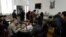 FILE - Journalists work in the press room of the Elysee Palace on March 27, 2018, in Paris. 