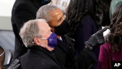 FILE - In this Jan. 20, 2021, file photo former President Barack Obama and former President George W. Bush look up to the crowd as they arrive for the 59th Presidential Inauguration at the U.S. Capitol for President-elect Joe Biden in Washington.