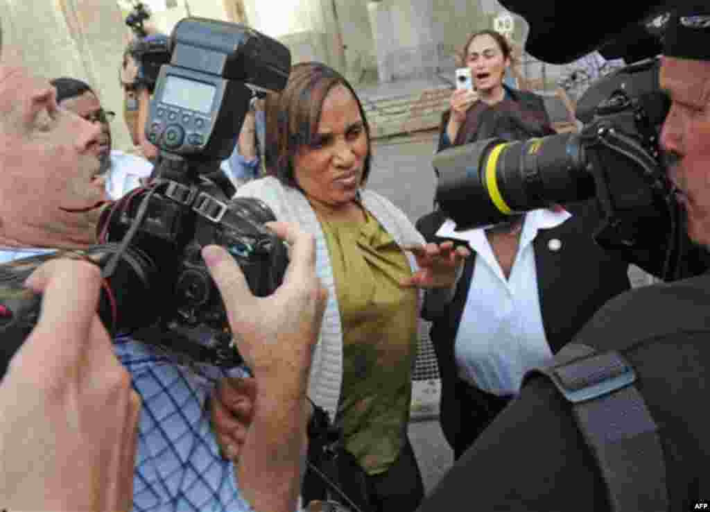 Nafissatou Diallo leaves Manhattan criminal court surrounded by a crush of photographers, Wednesday, July 27, 2011, in New York. Diallo, the hotel maid who accused Dominique Strauss-Kahn of sex assault met with prosecutors Wednesday morning for the first 