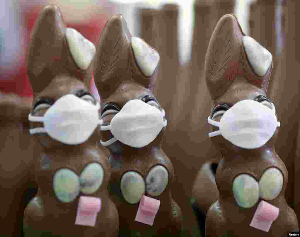 Chocolate Easter Bunnies with protective masks and rolls of toilet paper are seen at a chocolate factory in Pirmasens, Germany.